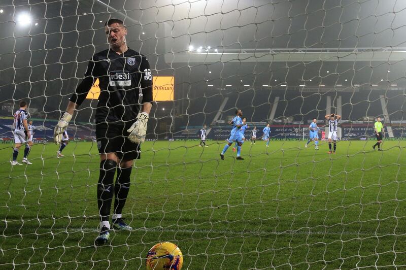 West Bromwich Albion's English goalkeeper Sam Johnston reacts after Manchester City's German midfielder Ilkay Gundogan scores. AFP