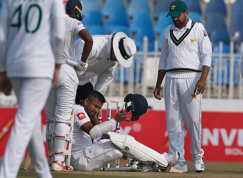 Sri Lanka batsman Dimuth Karunaratne, centre, was hit on the neck by a Naseem Shah hitting delivery in Rawalpindi on Wednesday. AP