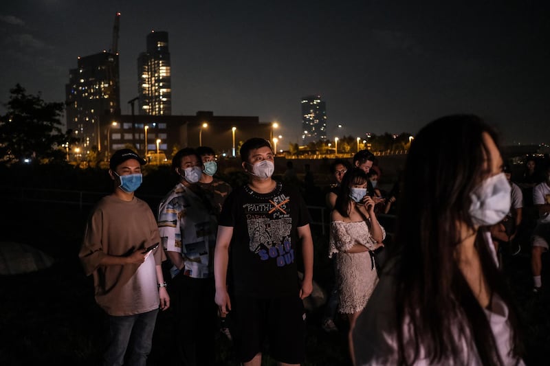 People gather to watch fireworks on the banks of the East River to celebrate Independence Day in Queens, New York City. AFP