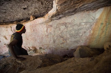 Traditional owner Ian Waina recording the painting of a kangaroo that has been dated at over 17,000 years old. Courtesy Peter Veth/ Balanggarra Aboriginal Corporation 