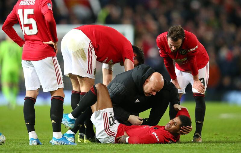 Marcus Rashford of Manchester United gets treatment after his injury at Old Trafford. Getty