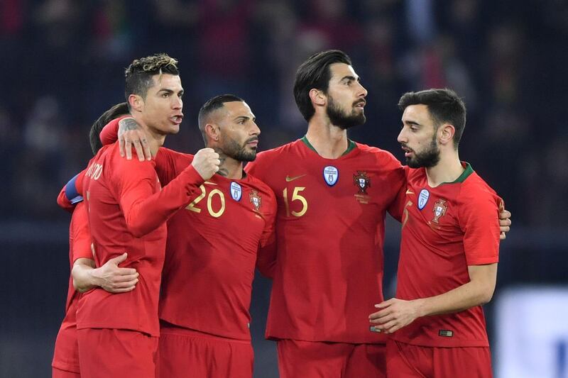 (From L) Portugal's forward Cristiano Ronaldo celebrates his second goal with teammates forward Ricardo Quaresma, midfielder Andre Gomes and midfielder Bruno Fernandes during an international friendly football match between Portugal and Egypt at Letzigrund stadium in Zurich on March 23, 2018. / AFP PHOTO / Fabrice COFFRINI
