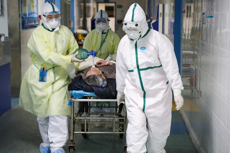 Medical workers in protective suits move a patient at an isolated ward of a hospital in Caidian district following an outbreak of the novel coronavirus in Wuhan, Hubei province, China. REUTERS