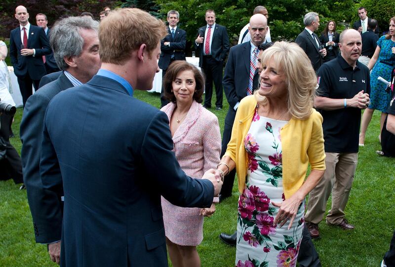 epa03209990 Britain's Prince Harry greets Dr. Jill Biden (R), the wife of U.S. Vice President Joe Biden, during a reception for U.S. and British wounded warriors at the British Ambassador's Residence in Washington, D.C., USA, on 07 May 2012. The wounded soldiers participated in the Warrior Games which is an event hosted every year by the US Olympic Committee.  EPA/KEVIN DIETSCH / POOL
