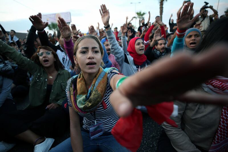 Demonstrators gesture as they block a road during ongoing anti-government protests in the port city of Sidon, Lebanon. Reuters