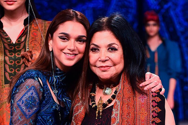 In this picture taken on February 13, 2020 Bollywood actress Aditi Rao Hydari poses with designer Ritu Kumar on the runway during  Lakme Fashion Week in Mumbai. AFP