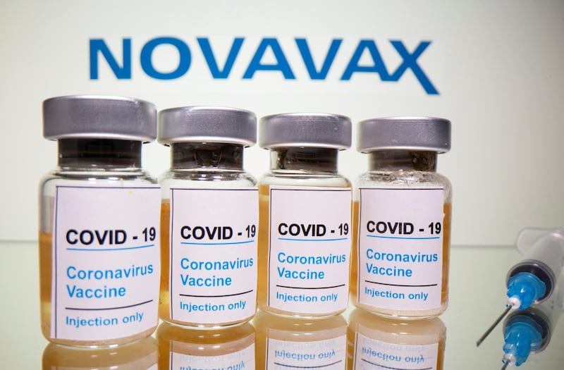 FILE PHOTO: Vials with a sticker reading, "COVID-19 / Coronavirus vaccine / Injection only" and a medical syringe are seen in front of a displayed Novavax logo in this illustration taken October 31, 2020. REUTERS/Dado Ruvic/Illustration/File Photo  GLOBAL BUSINESS WEEK AHEAD