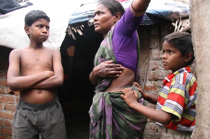 Nagamma, a victim of organ traffickers, with two of her three sons in front of her shack in the Korukkupet area of Chennai, India. Shaikh Azizur Rahman for The National