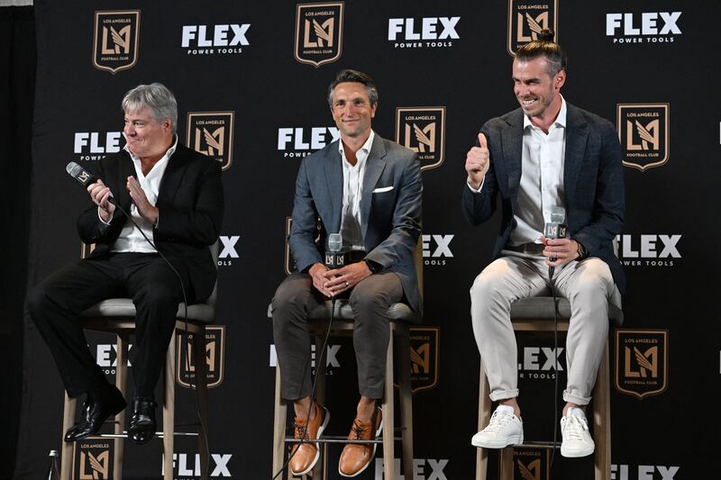Gareth Bale, right, is joined by Los Angeles Football Cub lead managing owner Larry Berg, left, and LAFC Co-President and General Manager John Thorrington as he is welcomed to Major League Soccer's Los Angeles Football Club (LAFC). AFP
