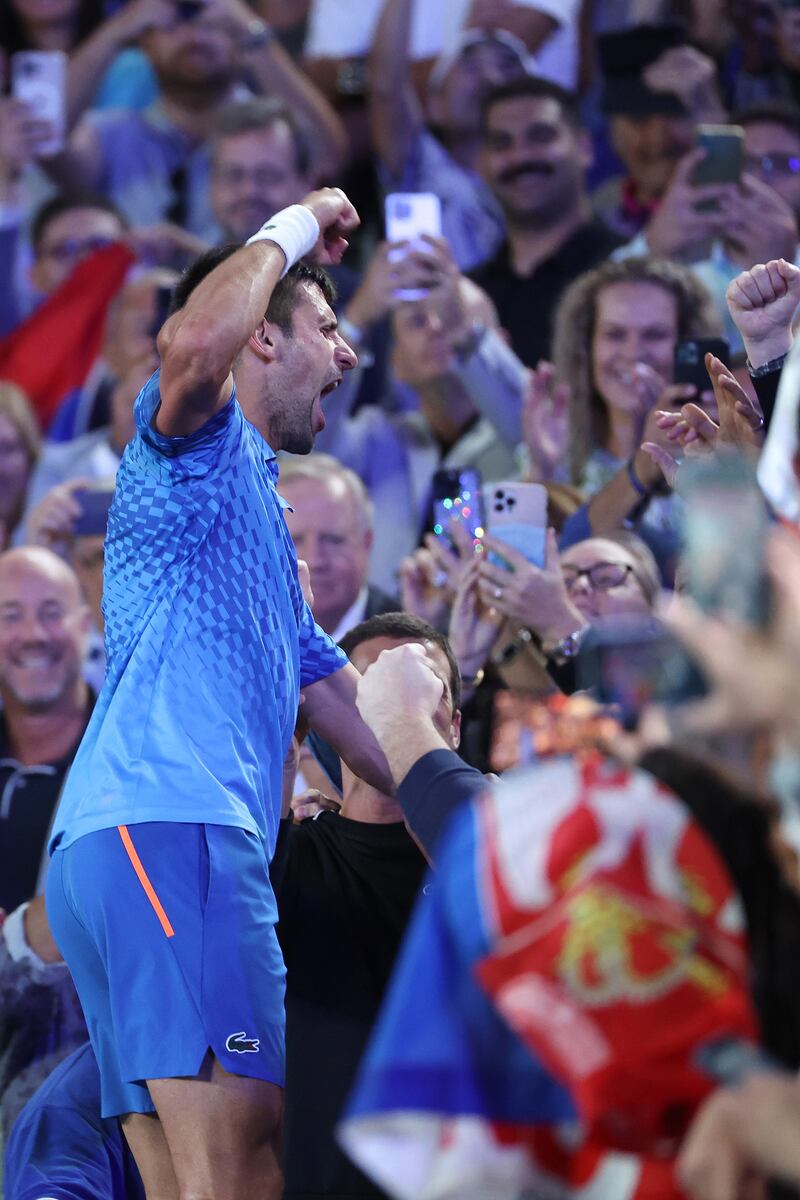 Novak Djokovic celebrates winning championship point in his players' box. Getty