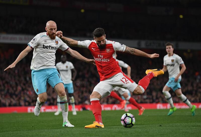 Olivier Giroud of Arsenal is challenged by James Collins of West Ham United. Shaun Botterill / Getty Images