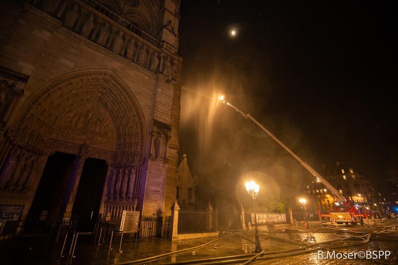 epa07509707 A handout photo made available by the Brigade de Sapeurs-Pompiers de Paris (BSPP) on 16 April 2019 shows French fire fighters in operation to extinguish a fire burning the roof of the Notre-Dame Cathedral in Paris, France, 15 April 2019. A fire started in the late afternoon in one of the most visited monuments of the French capital.  EPA/BENOIT MOSER / BSPP / HANDOUT  HANDOUT EDITORIAL USE ONLY/NO SALES