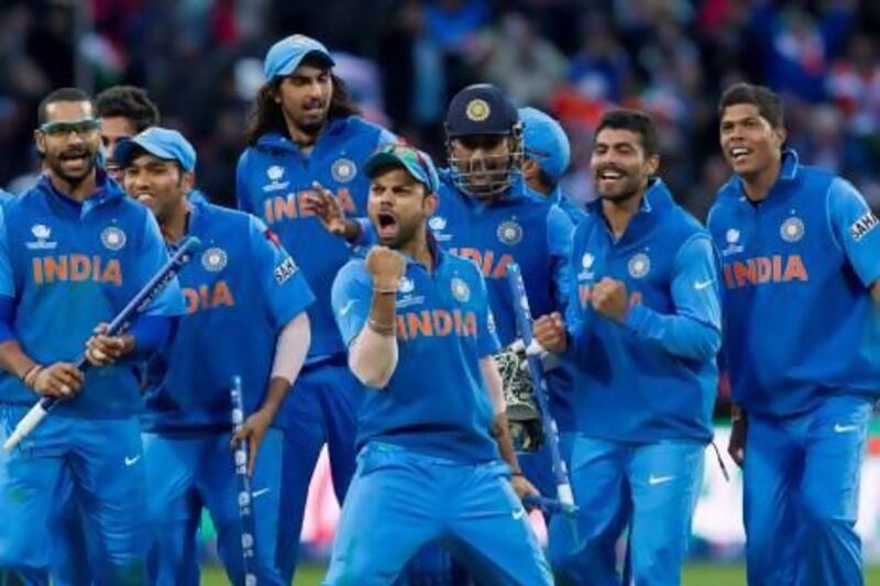 Virat Kohli, centre, and his India teammates celebrate beating England in the ICC Champions Trophy final on Sunday at Edgbaston cricket ground in Birmingham, England. Jon Super / AP Photo