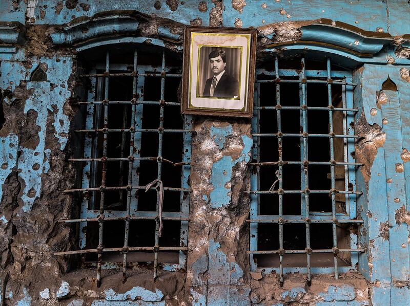 A portrait of an Iraqi man hangs on the wall of a heavily-damaged house in the Old City of Mosul. AFP