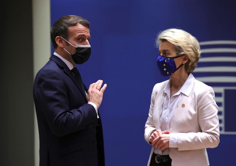 Macron speaks with European Commission President Ursula von der Leyen at an EU summit in Brussels on December 10. AP Photo