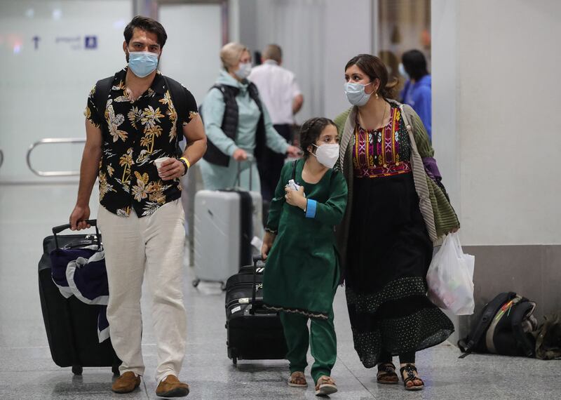 People among the first evacuees from Kabul, arrive at Frankfurt International Airport in western Germany in the early hours of August 18, 2021. AFP