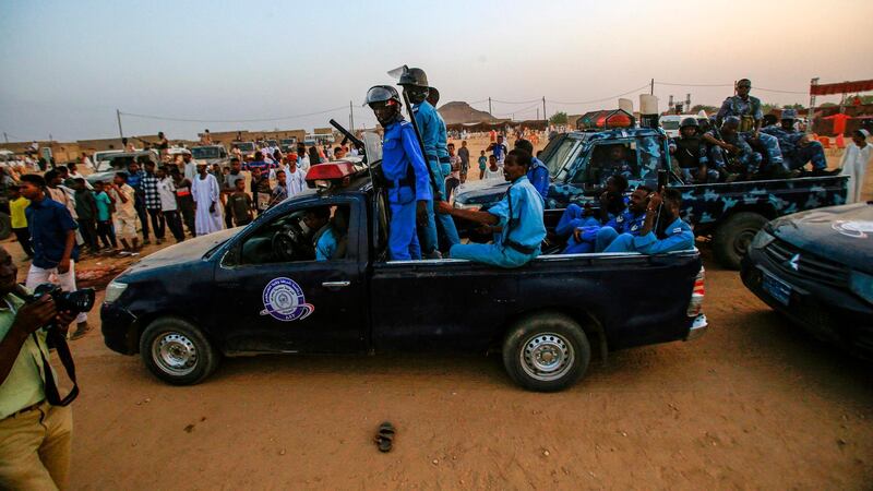 Sudanese members of the local police force ride in the back of a pickup truck during a rally in the village of Qarri, about 90 kilometres north of Khartoum.  AFP