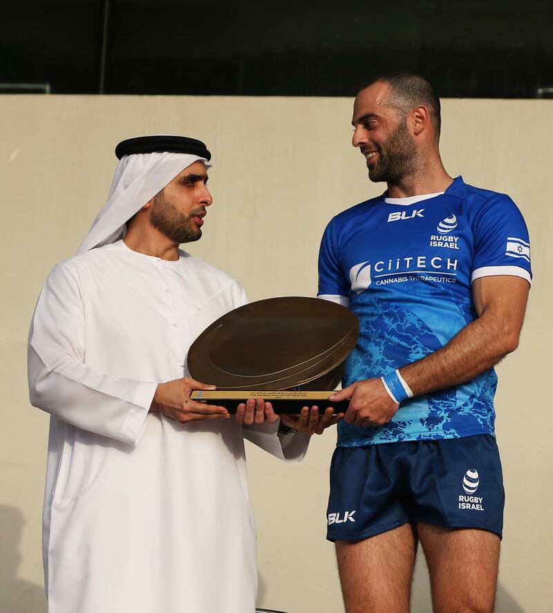 Israel player Gal Aviram receives the Abraham Accord Friendship Cup trophy from Sheikh Mohammed Bin Maktoum Bin Juma Al Maktoum, chairman of the UAE Rugby Federation. EPA