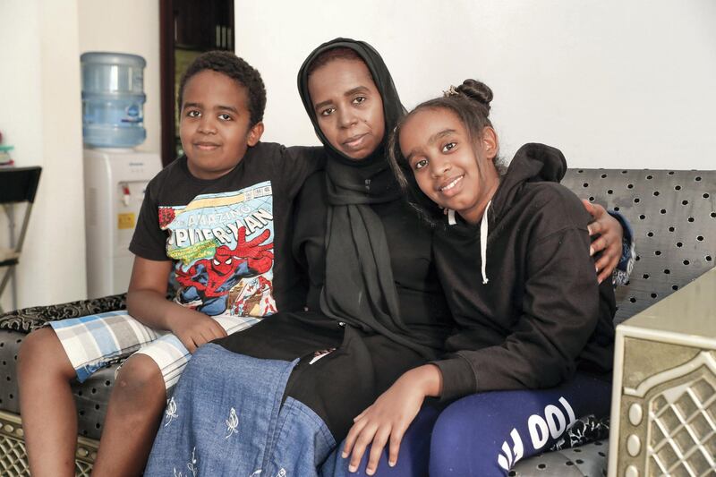 Dubai, UAE, April 21, 2018.  Abeer Khafaga’s husband became paralyzed after a stroke in 2014. Since then he has been unable to work leaving his wife doing odd jobs to provide the family’s basic needs but they still can’t pay for rent or residency fees. (L-R)  Abdulrahman-10, Abeer and Hagir-11. at their apartment at Al Nahda 2 Dubai.
Victor Besa / The National
National
Reporter: Shareena Al Nuwais