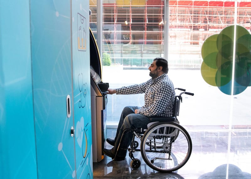 DUBAI, UNITED ARAB EMIRATES. 11 SEPTEMBER 2019. 
Mohammad Zeeshan uses an ATM at Tanfeeth’s office, that has been specifaclly made to a heigh suitable for their employees with determination.

Hiring people with disabilities - Emirates NBD has set up a Careers Network in which they have placed close to 70 people with disabilities in different sectors from banking to the hotels. We meet two staffers with disabilities and their employer. This is ahead of a meet-up next week the bank has set where they will link employers with people with disabilities in Dubai 

(Photo: Reem Mohammed/The National)

Reporter:
Section: