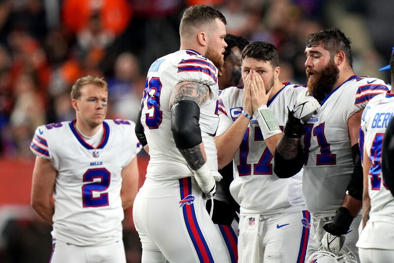 Buffalo Bills quarterback Josh Allen and his teammates gather on the field. USA Today