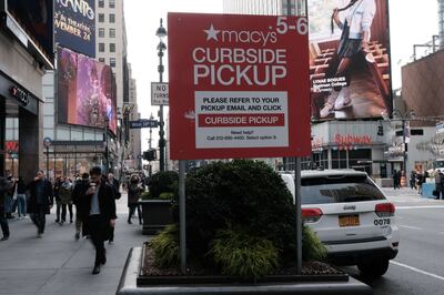 A Macy's curbside pickup sign in Manhattan. Some people rely on online grocery ordering with curbside pick-up to save money. AFP
