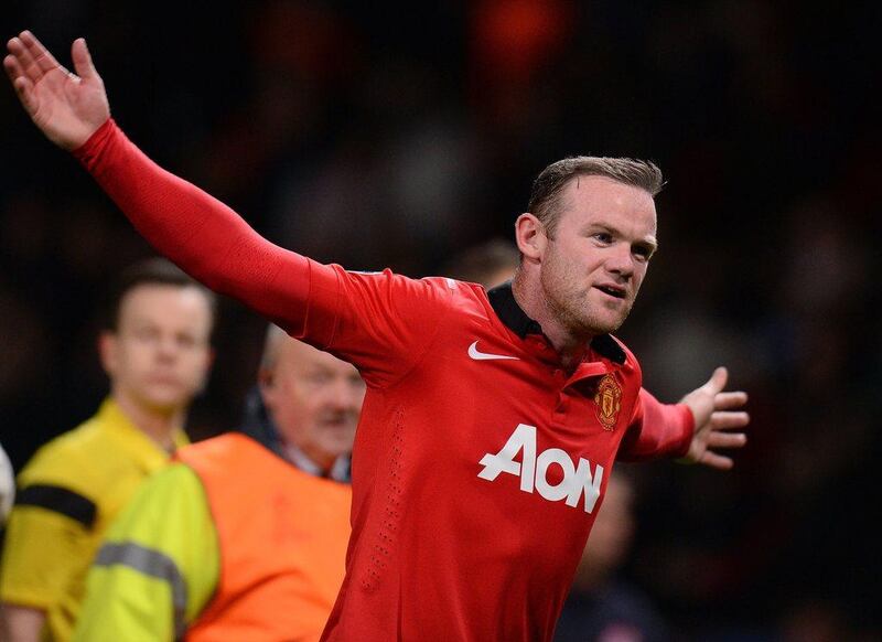 Manchester United forward Wayne Rooney gestures as he leaves the pitch following the Wednesday's victory. Andrew Yates / AFP / March 19, 2014