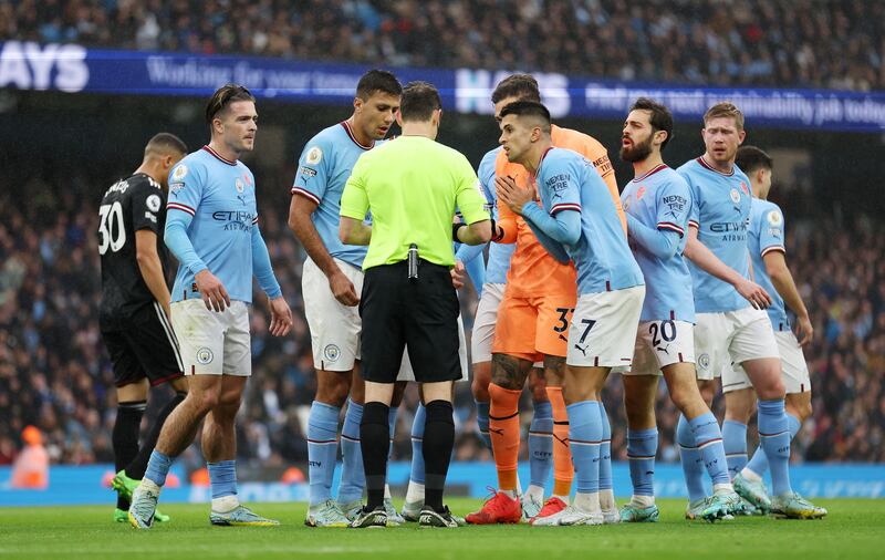 Joao Cancelo of Manchester City appeals to referee Darren England after being red carded. Getty