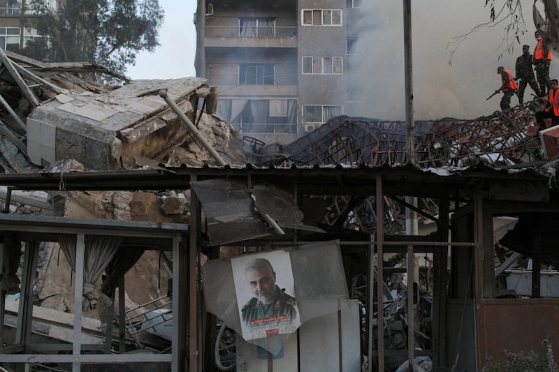 A picture of late Iranian military commander Qassem Suleimani hangs at the scene of Monday's Israeli air strike on Iran's embassy in Damascus. Reuters