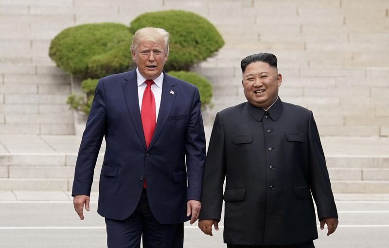 FILE PHOTO: U.S. President Donald Trump meets with North Korean leader Kim Jong Un at the demilitarized zone separating the two Koreas, in Panmunjom, South Korea, June 30, 2019. REUTERS/Kevin Lamarque/File Photo