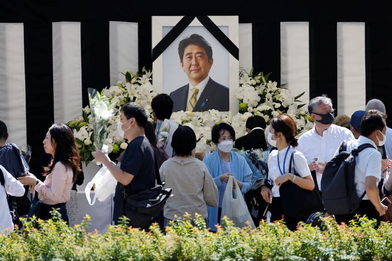 An altar was set up with Abe's picture outside the funeral venue. Reuters