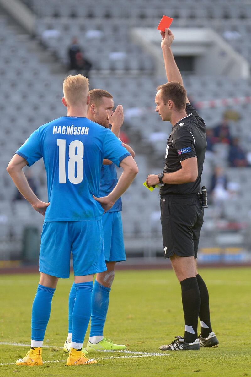 Referee Srdjan Jovanovic shows the red card to Sverrir Ingason after the  Iceland defender conceded a penalty for handball. AFP