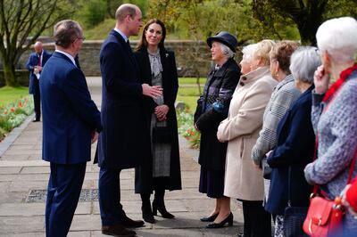 The Prince and Princess of Wales speak to members of the Aberfan Wives group, who lost relatives in the 1966 disaster, in the Welsh village's memorial garden. AFP