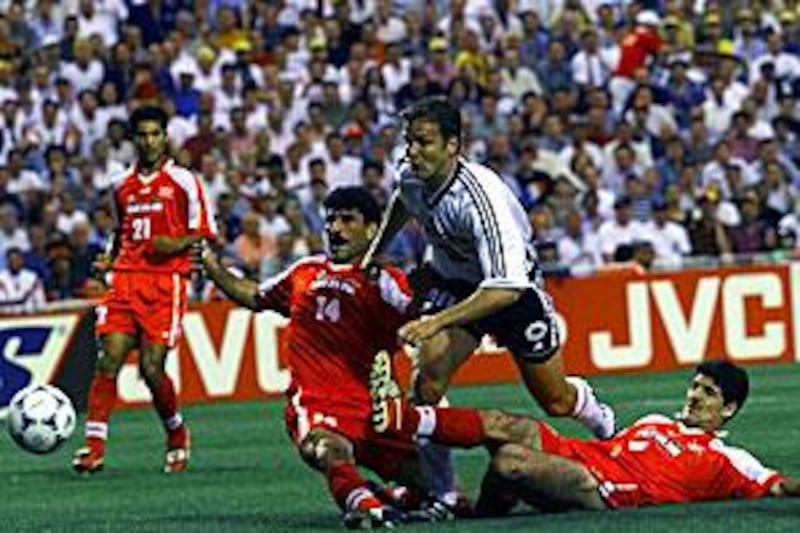 Germany's Oliver Bierhoff is tackled by Iran's Nader Mohammadkhani, left, and Karim Bagheri, right, during their meeting in France '98. Although Iran failed to win they did have the satisfaction of beating the US.