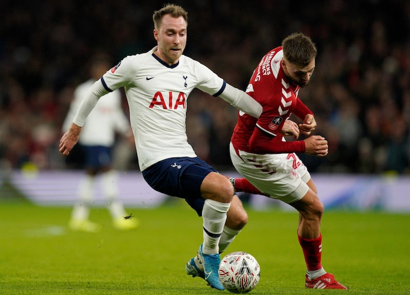 Christian Eriksen vies for the ball against Middlesborough's Lewis Wing. EPA