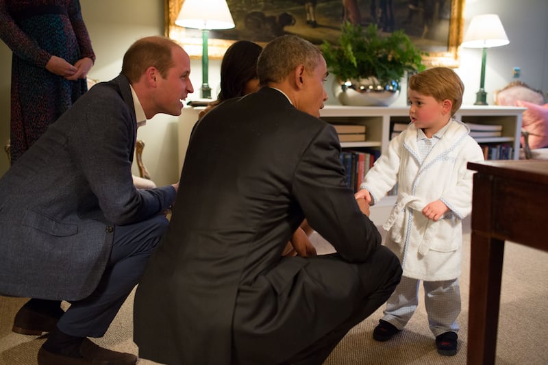 US President Barack Obama, Prince William, and US first lady Michelle Obama speak with Prince George at Kensington Palace in 2016. Getty Images