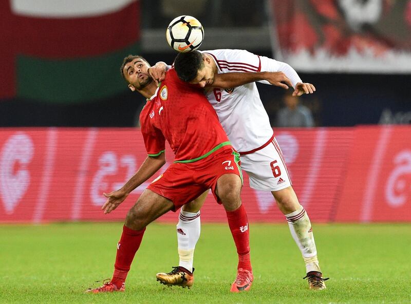 Oman's Khalid Al Hajiri, left, in action against UAE's Mohanad Salem. Noufal Ibrahim / EPA