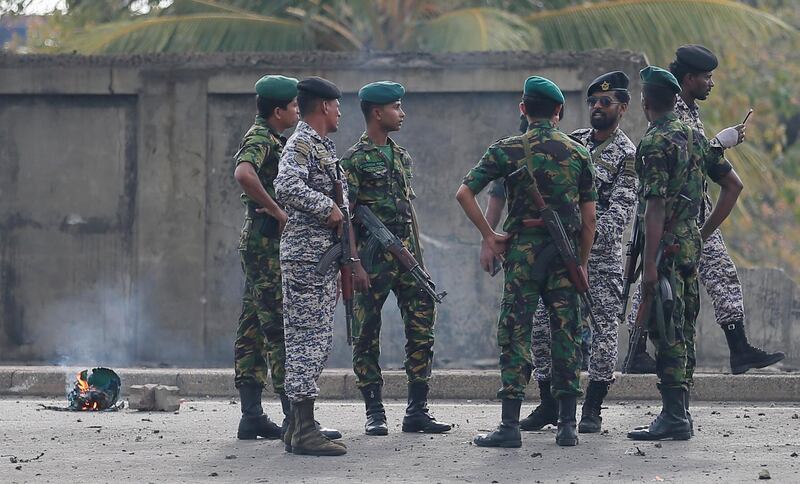 Bomb squad officers inspect the site of an exploded van near a church that was attacked in Colombo, Sri Lanka. Reuters