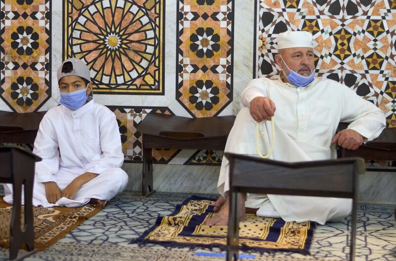 A man and a boy attend Friday prayers at Al Husseini mosque in Amman, Jordan. Reuters