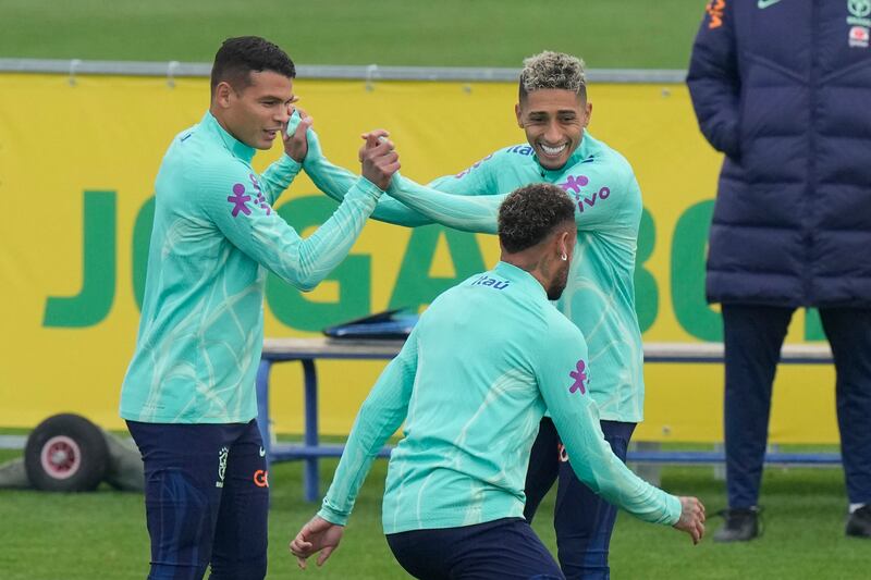 Thiago Silva, left, and Raphinha joke with Neymar during a training session at the Continassa sporting centre in Turin on November 17. AP