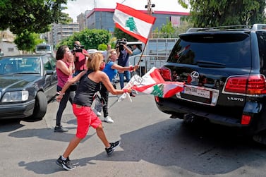 Lebanese anti-government protesters harrass a vehicle belonging to an MP arriving for a parliamentary session at the Unesco Palace in Beirut. AFP