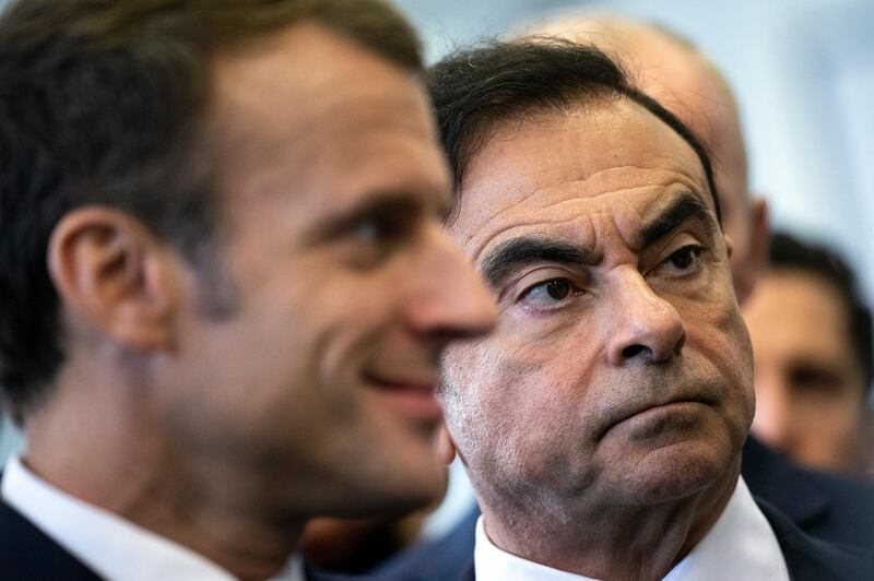 FILE - In this Nov. 8, 2018, file photo, French President Emmanuel Macron, left, and Renault CEO Carlos Ghosn visit the Renault factory in Maubeuge northern France. A trailblazer and visionary in the auto industry, Ghosn is also a highflyer prone to excesses that may have helped bring on his surprise downfall as head of the worldâ€™s best-selling auto group. Ghosn was arrested last week in Japan for allegedly falsifying financial reports and misusing funds at Nissan Motor Co. It was a stunning reversal for the industry icon. (Etienne Laurent, Pool via AP, File)