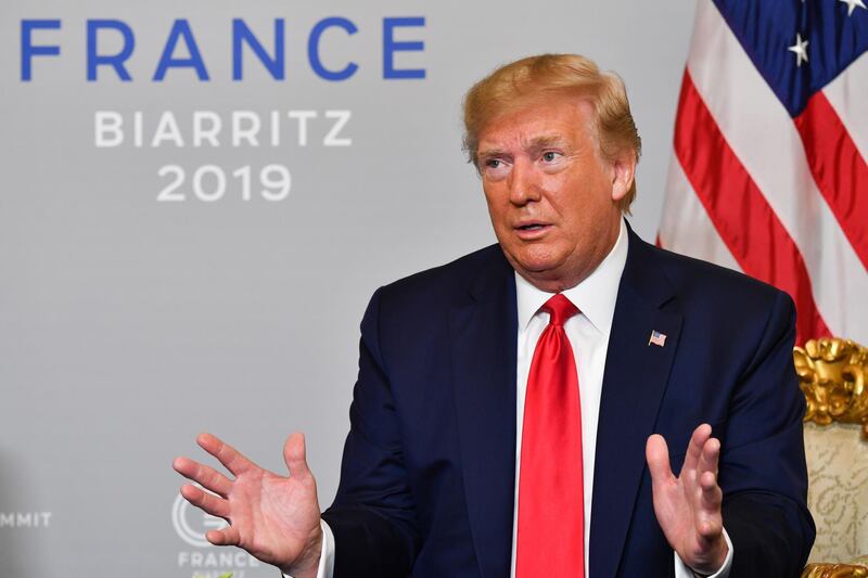 TOPSHOT - US President Donald Trump reacts during his a bilateral meeting with Egyptian President and Chairman of the African Union Abdel Fattah al-Sissi in Biarritz, south-west France on August 26, 2019, on the third day of the annual G7 Summit. / AFP / Nicholas Kamm
