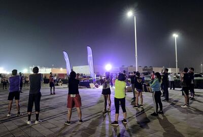 Abu Dhabi, United Arab Emirates, September 23, 2019.    
ADNOC Marathon training with Last year’s winner Marius Kipserem at Al Hudayriat Island.  -- Participants do some stretching excercises to warm up before the run.
Victor Besa / The National
Section:  NA
Reporter:  Dan Sanderson