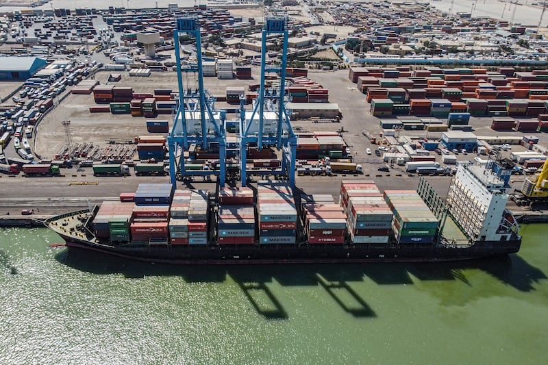 An aerial view of containers being unloaded from a cargo ship moored at the port of Umm Qasr, south of Iraq's southern city of Basra.