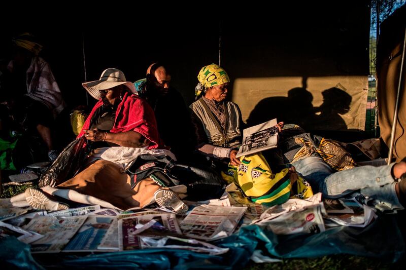 African National Congress (ANC) supporters camp outside the ANC's 54th national conference on December 18, 2017 in Johannesburg. 
Thousands of delegates from South Africa's ruling ANC party began voting for their new leader in the early hours of Monday morning, officials said, shortly after saying the vote had been delayed. / AFP PHOTO / GULSHAN KHAN