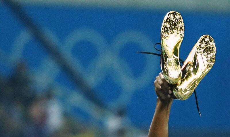 Usain Bolt of Jamaica holds up his shoes after winning the gold in the men’s 100m final at the Rio 2016 Olympics at the Olympic Stadium on August 14, 2016 in Rio de Janeiro, Brazil. Lucy Nicholson / Reuters