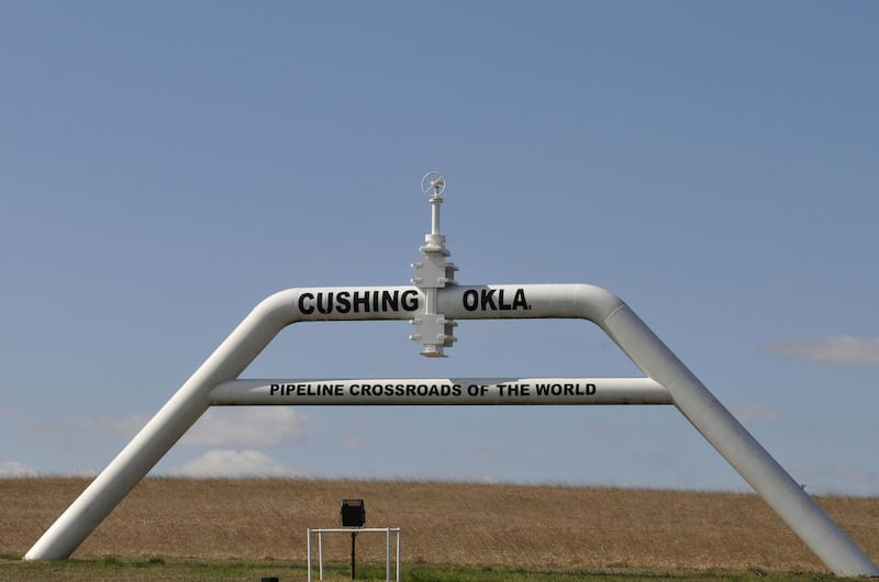 A sign built out of a pipeline that reads "pipeline crossroads of the world" welcomes visitors to town in Cushing, Oklahoma, March 24, 2016. REUTERS/Nick Oxford