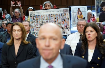 A placard with photos of those killed on Ethiopian Airlines Flight 302 is held up as Boeing's CEO, Dave Calhoun, testifies before the US Senate in Washington this week. Reuters