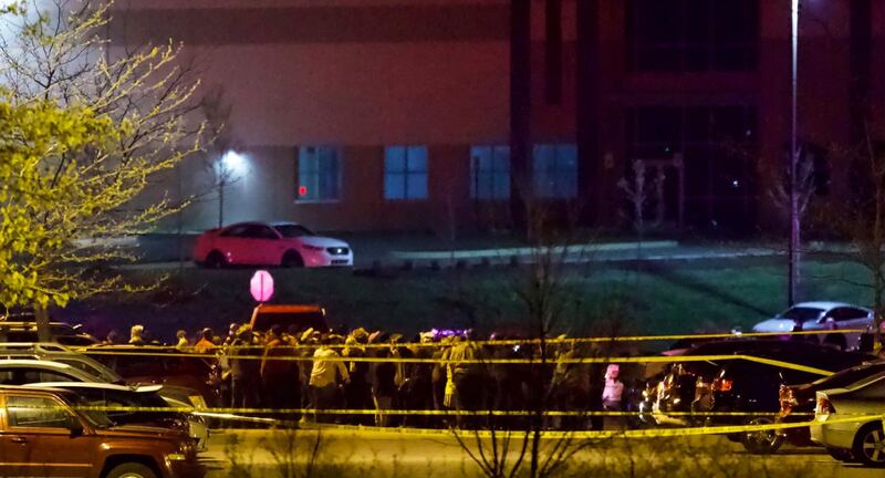 People stand outside a FedEx facility near Indianapolis International Airport after a shooting with multiple victims was reported late Thursday night, April 15, 2021. AP Photo